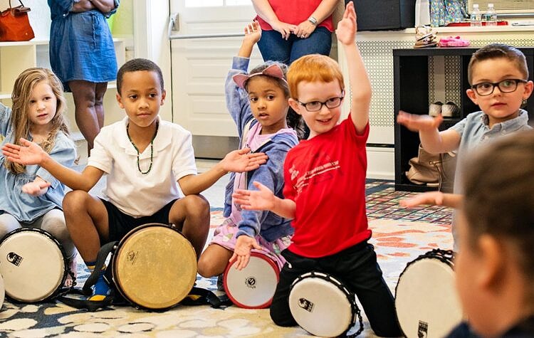 Children singing and playing instruments